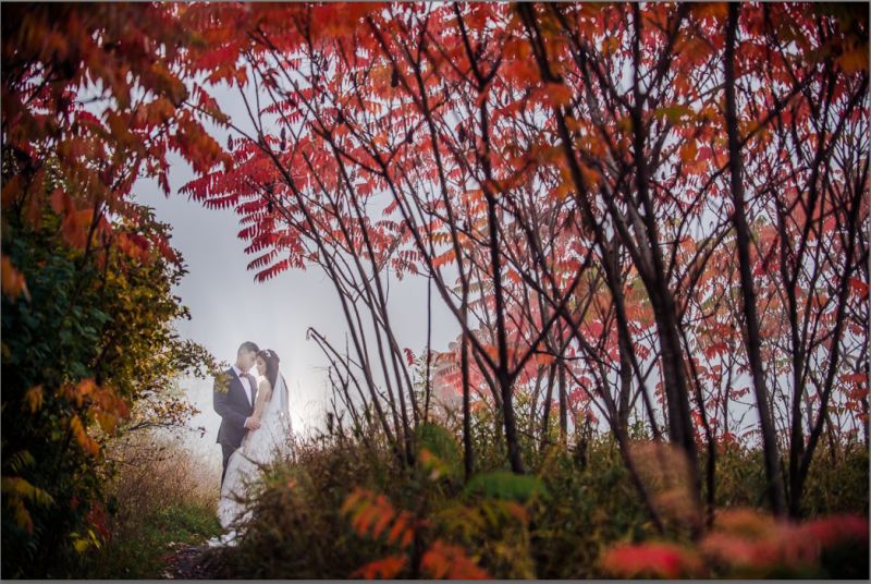 A wedding shot in Autumn with all the gorgeous red leaves.