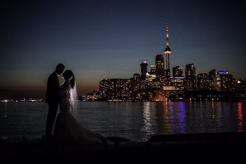 A wedding shot with the night view of Toronto skyline.